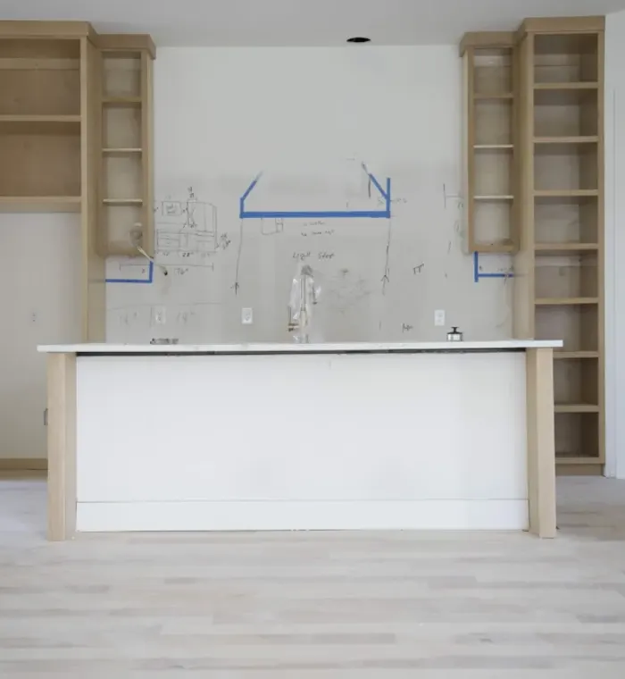 Kitchen island and custom shelving under construction on an Altura renovation
